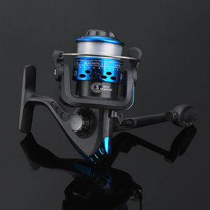 Fishing reel with gold and black design on a reflective black surface