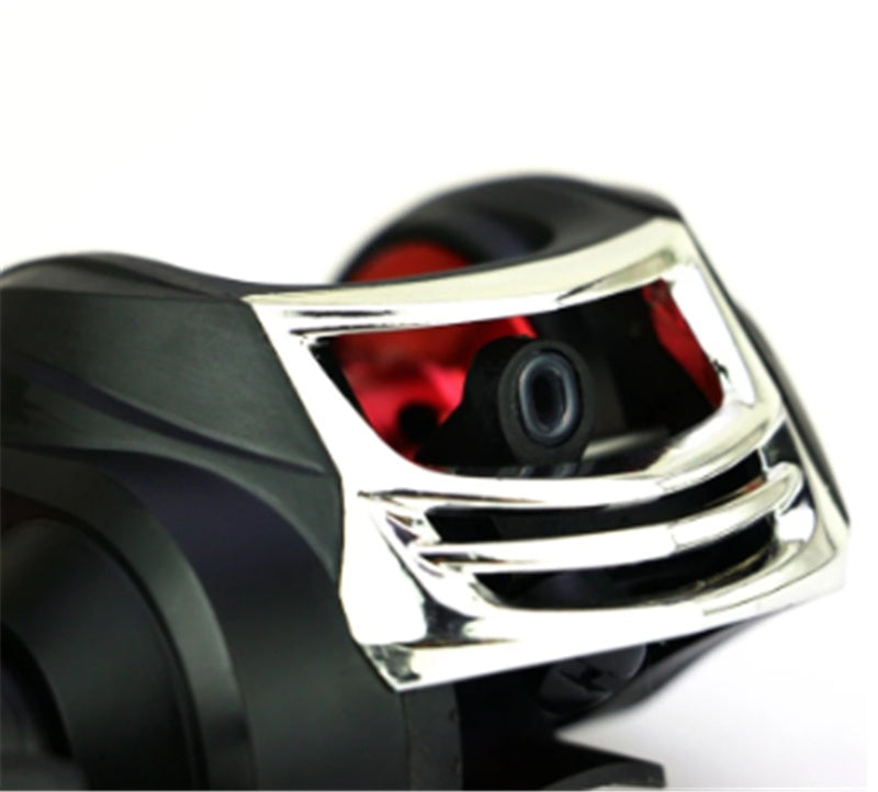Close-up of a motorcycle headlight with chrome finish and red interior on a white background