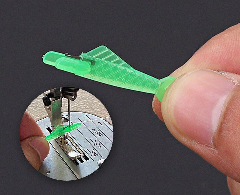 Green plastic tool being held by a hand with a close-up inset showing its use on sewing machine needles.