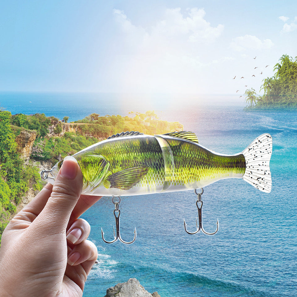 Fishing lure held by a hand with a scenic background of water and greenery.