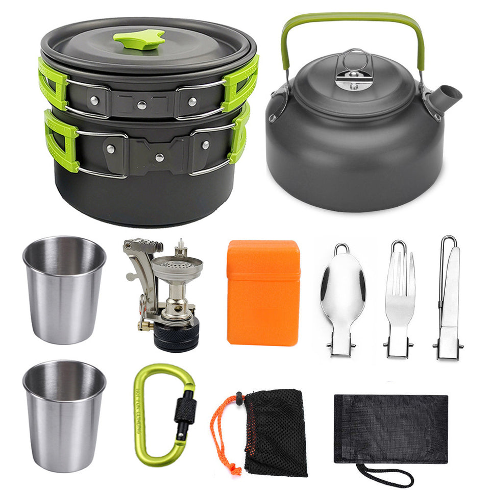 Collection of camping and outdoor cooking equipment including a pot, kettle, cups, utensils, and a carabiner.