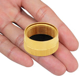 Gold-colored female hose connector held in a hand against a white background