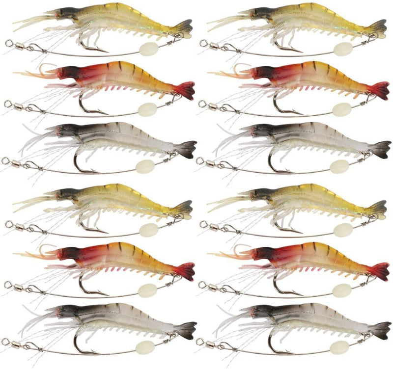 Twelve fishing shrimp lures arranged in a 4-by-3 grid on a plain white background. The lures vary in color between yellow, red, orange, and gray, each with a treble hook and split bead tail.
