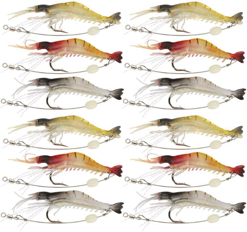Twelve fishing shrimp lures arranged in a 4-by-3 grid on a plain white background. The lures vary in color between yellow, red, orange, and gray, each with a treble hook and split bead tail.
