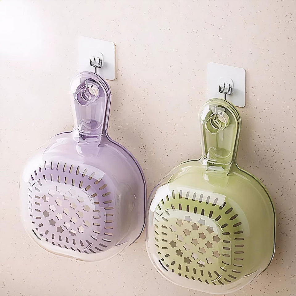 Two wall-mounted kitchen strainers, one purple and one green, on a light-colored wall.
