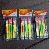 Foam storage for fishing lures and hooks on a wooden surface.