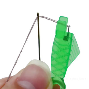 Close-up of a sewing machine needle and mechanism with a green background