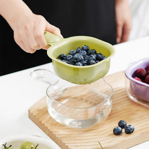 Purple colander with dimensions labeled on a white background