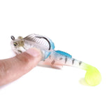 Transparent fishing lure with a hook, held by a finger against a white background